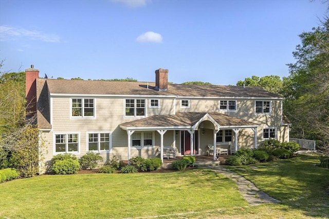 view of front of house featuring a patio, a front yard, and covered porch