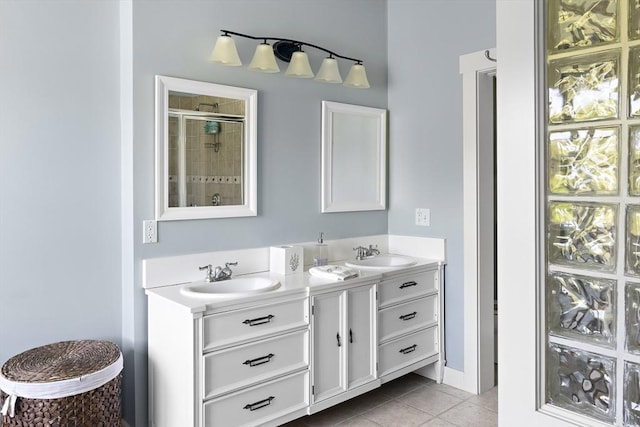 bathroom featuring a shower with door, tile patterned floors, and vanity