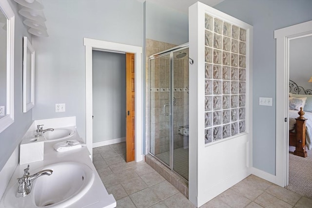 bathroom featuring vanity, an enclosed shower, and tile patterned floors