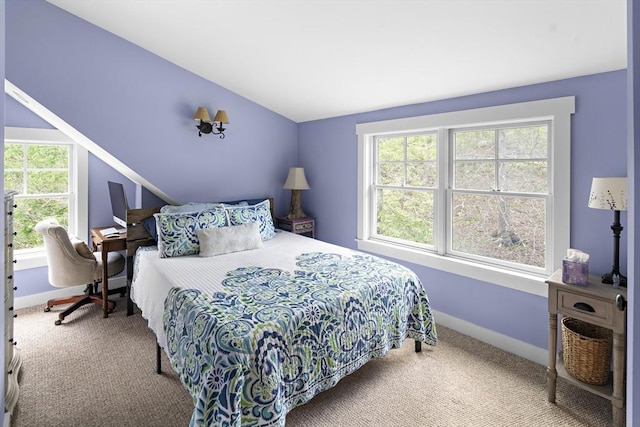 carpeted bedroom with lofted ceiling