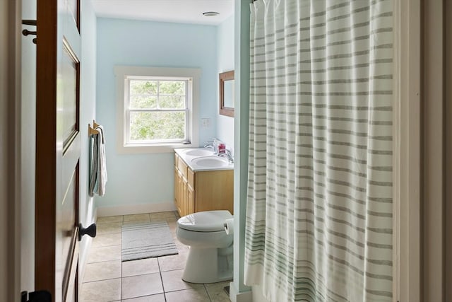 bathroom featuring toilet, vanity, tile patterned flooring, and curtained shower