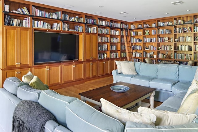 living room featuring hardwood / wood-style floors and built in features