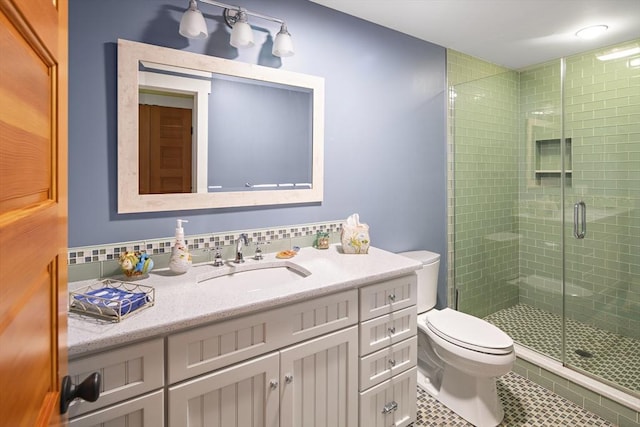 bathroom featuring toilet, an enclosed shower, tile patterned flooring, and vanity