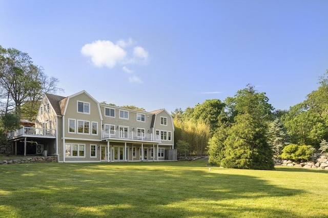 back of house featuring a yard and a wooden deck