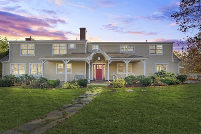 view of front of house featuring a porch and a lawn