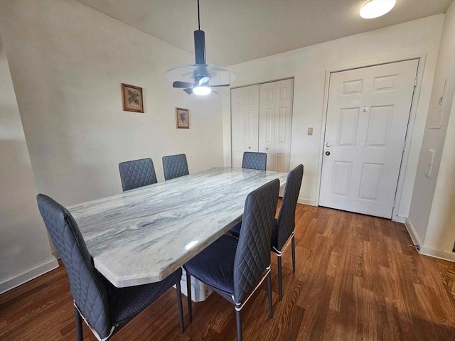 dining area with ceiling fan and dark hardwood / wood-style floors