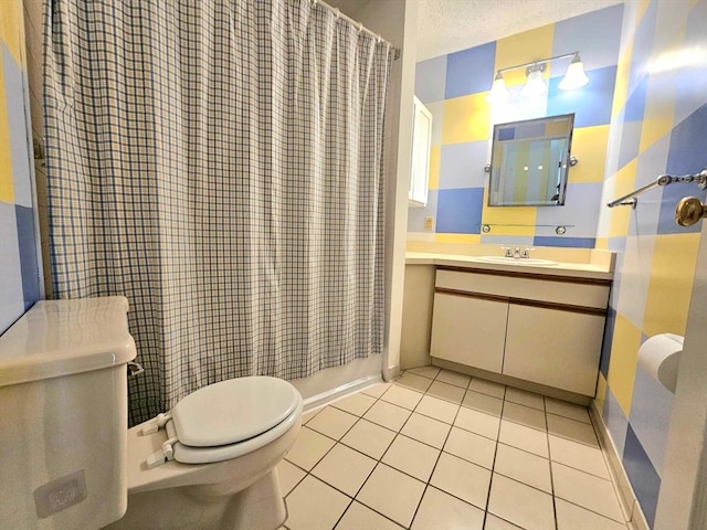 full bathroom with a textured ceiling, vanity, toilet, and tile patterned flooring