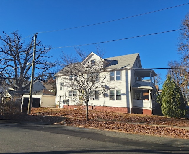 view of front of house with a garage and an outbuilding