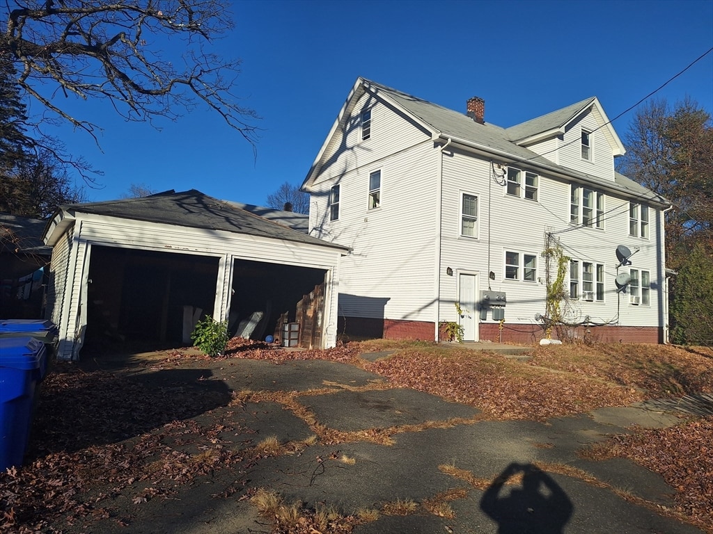 view of side of property featuring a garage and an outdoor structure