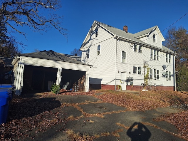 view of side of property featuring a garage and an outdoor structure