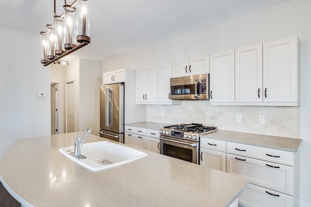 kitchen with tasteful backsplash, a kitchen island with sink, stainless steel appliances, white cabinetry, and a sink