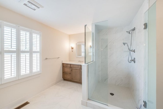 bathroom with a healthy amount of sunlight, visible vents, vanity, and a marble finish shower