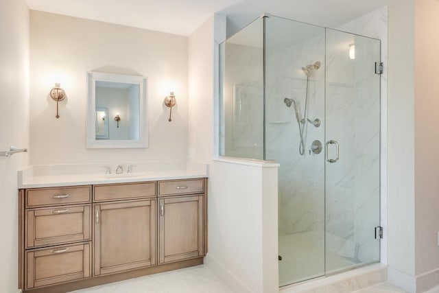 full bathroom with marble finish floor, baseboards, vanity, and a marble finish shower