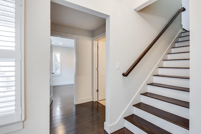 stairs with wood finished floors and baseboards