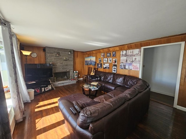 344 Frieda St, New Bedford, MA 02744 - living room with wooden walls, wood finished floors, and a stone fireplace
