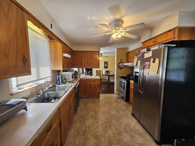 344 Frieda St, New Bedford, MA 02744 - kitchen with stainless steel appliances, a sink, brown cabinets, a ceiling fan, and light countertops