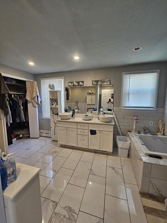 344 Frieda St, New Bedford, MA 02744 - bathroom with double vanity, a tub with jets, a baseboard heating unit, marble finish flooring, and recessed lighting