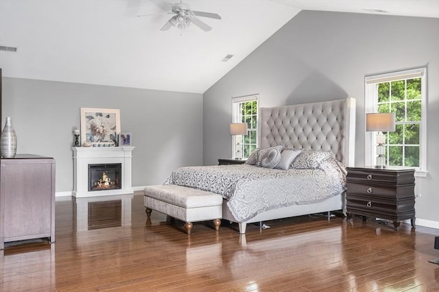 6 Paddock Dr, Lincoln, RI 02865 - bedroom featuring vaulted ceiling, wood finished floors, baseboards, a lit fireplace, and a ceiling fan