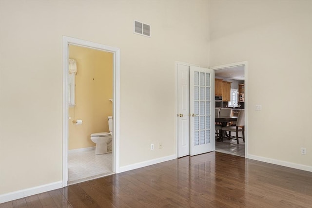 6 Paddock Dr, Lincoln, RI 02865 - unfurnished bedroom with wood finished floors, baseboards, a high ceiling, a sink, and connected bathroom