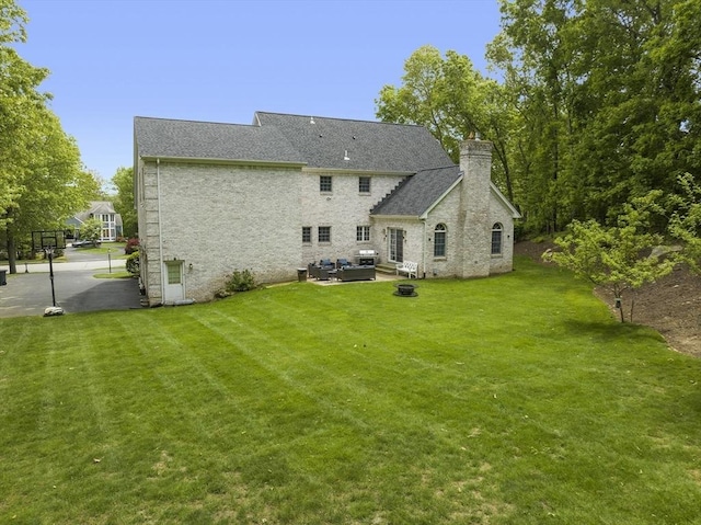 6 Paddock Dr, Lincoln, RI 02865 - back of property featuring a lawn, an outdoor hangout area, a chimney, and a patio area