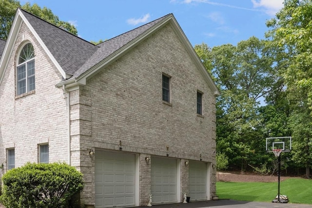 6 Paddock Dr, Lincoln, RI 02865 - view of side of home featuring a garage, a shingled roof, brick siding, and a lawn