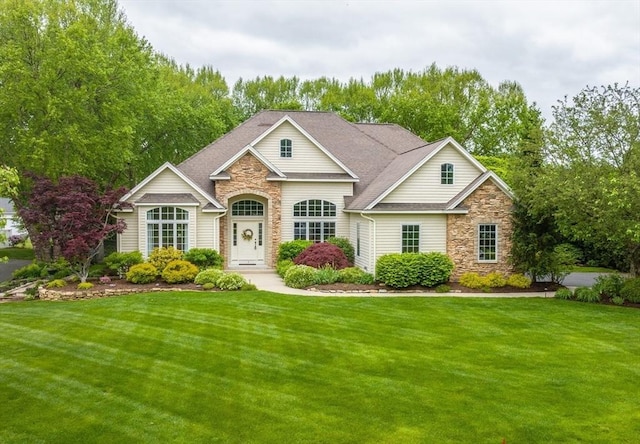 7 Brimfield Way, Westfield, MA 01085 - traditional-style house with stone siding, a front lawn, and roof with shingles
