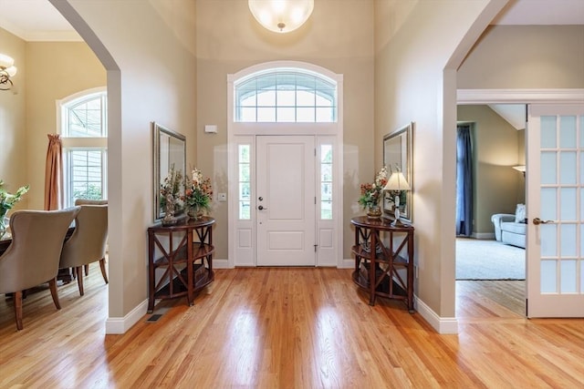 7 Brimfield Way, Westfield, MA 01085 - foyer featuring arched walkways, a towering ceiling, light wood-type flooring, baseboards, and a chandelier