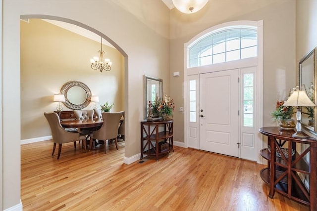 7 Brimfield Way, Westfield, MA 01085 - entryway with arched walkways, wood finished floors, a towering ceiling, a chandelier, and baseboards