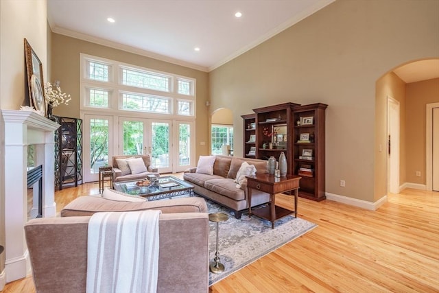 7 Brimfield Way, Westfield, MA 01085 - living area featuring arched walkways, ornamental molding, a high ceiling, light wood-style floors, and baseboards
