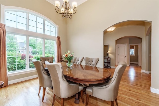 7 Brimfield Way, Westfield, MA 01085 - dining room with arched walkways, baseboards, light wood-style floors, a chandelier, and ornamental molding