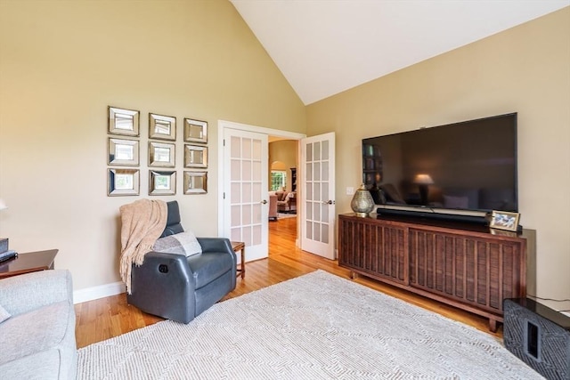 7 Brimfield Way, Westfield, MA 01085 - living room featuring french doors, wood finished floors, high vaulted ceiling, and baseboards