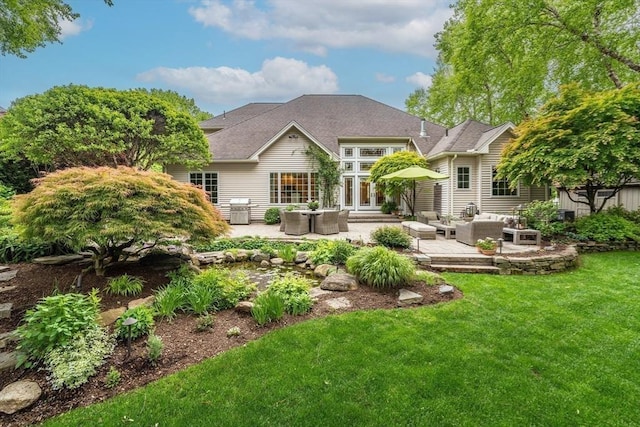 7 Brimfield Way, Westfield, MA 01085 - rear view of house with outdoor lounge area, a lawn, and a patio area