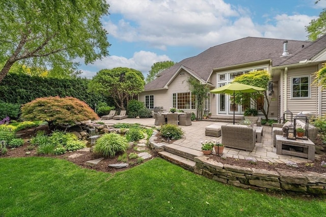 7 Brimfield Way, Westfield, MA 01085 - rear view of house with an outdoor hangout area, a lawn, and a patio