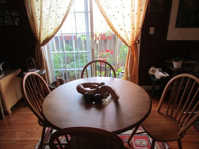 dining area with hardwood / wood-style flooring and plenty of natural light