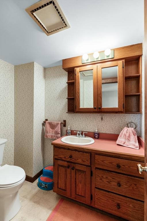 bathroom featuring vanity and toilet