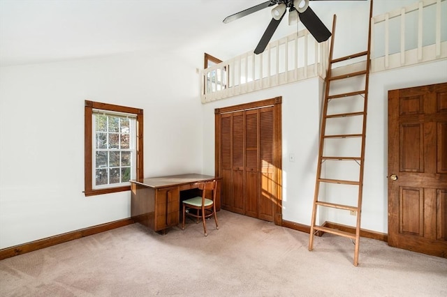 interior space featuring light colored carpet, high vaulted ceiling, and ceiling fan