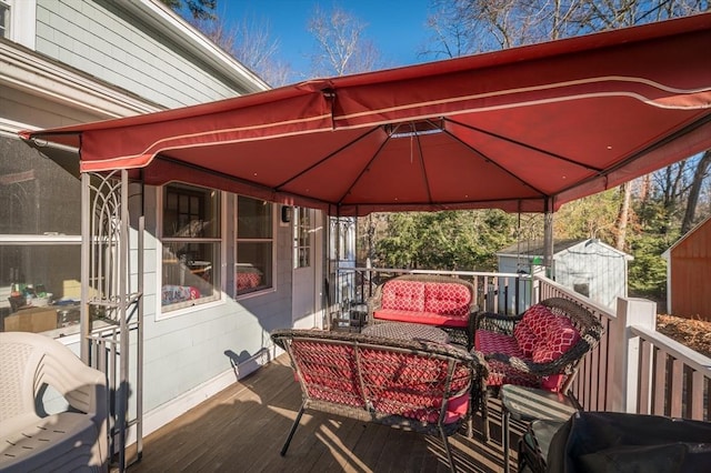 wooden terrace with a gazebo and a shed