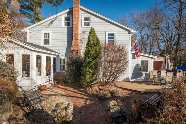 back of house featuring a sunroom and a patio