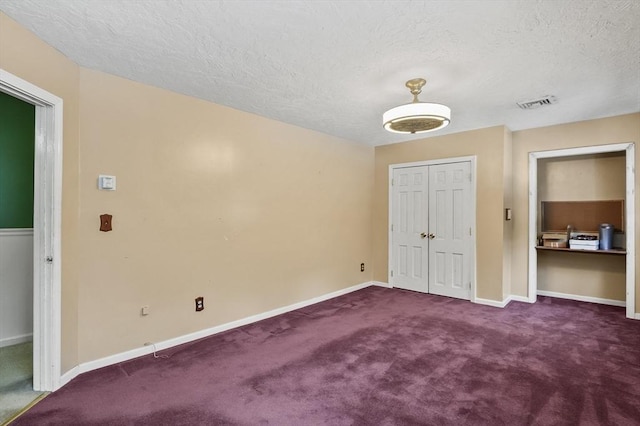 29 Shady Ave, Westminster, MA 01473 - unfurnished bedroom featuring a textured ceiling, visible vents, baseboards, a closet, and dark colored carpet