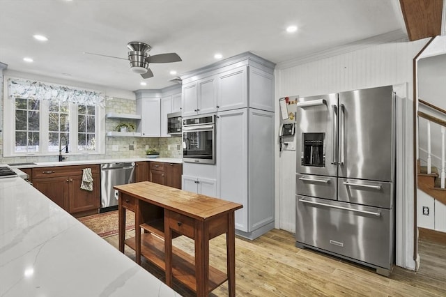 29 Shady Ave, Westminster, MA 01473 - kitchen with open shelves, light wood-style flooring, decorative backsplash, appliances with stainless steel finishes, and light stone countertops