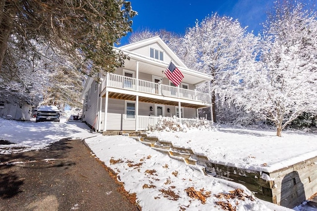 view of front property featuring a balcony and covered porch