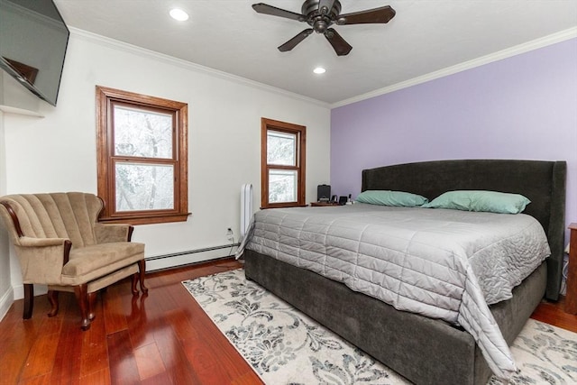 bedroom with ceiling fan, ornamental molding, baseboard heating, and dark hardwood / wood-style flooring