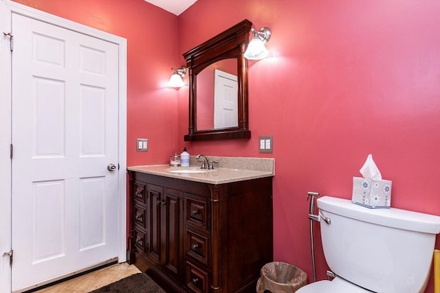 bathroom with toilet and vanity