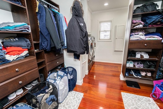 walk in closet with separate washer and dryer and wood-type flooring