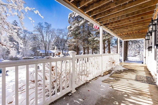 view of snow covered back of property