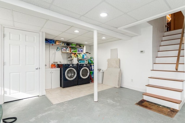 basement with independent washer and dryer and a drop ceiling