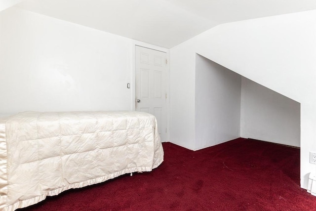 carpeted bedroom featuring lofted ceiling