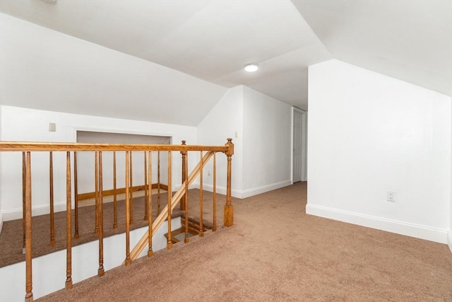 bonus room with carpet floors and lofted ceiling