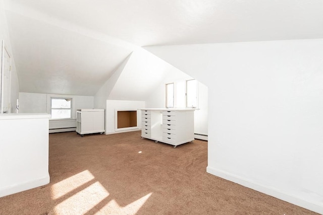 bonus room featuring baseboard heating, carpet flooring, and vaulted ceiling