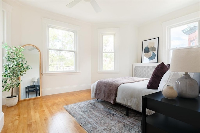 bedroom featuring hardwood / wood-style flooring, baseboards, and ceiling fan